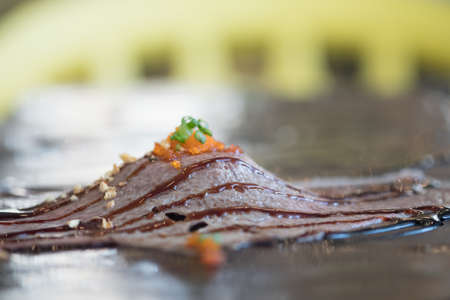 Selective focust to grilled Wagyu beef sushi with fish roe on black plate in Japanese restaurant. Japanese foodの写真素材