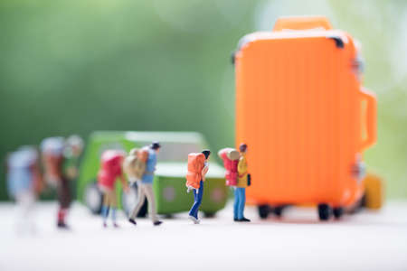 Miniature people : Group of travelers with orange suitcase. Image use for travel, business concept and the adventure.の写真素材