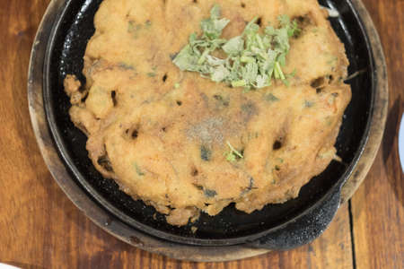 Crispy Thai Mussel Omelet served on hot pan, top viewの写真素材