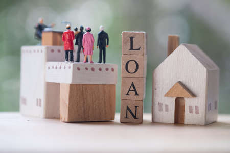 Miniature people contact and agreement banking to contact for approve home loans. Concept of the financial loans between the lender and the borrower. Secured and mortgage loan.の写真素材