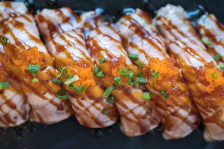 Row of burned salmon with sauce. Japanese mealの写真素材