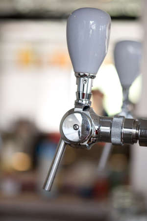 Close up of metallic beer taps in a barの写真素材
