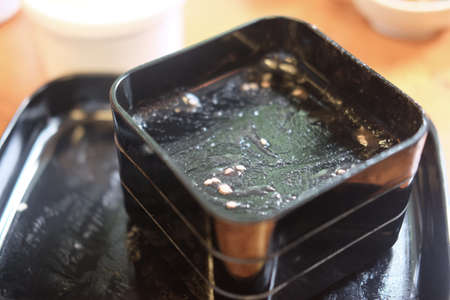 Customers leave dirty black tray and dirty tables in Shabu restaurantの写真素材