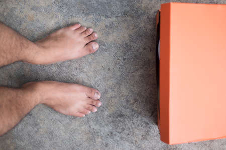 Men choosing sports shoes, new shoes in orange boxの写真素材