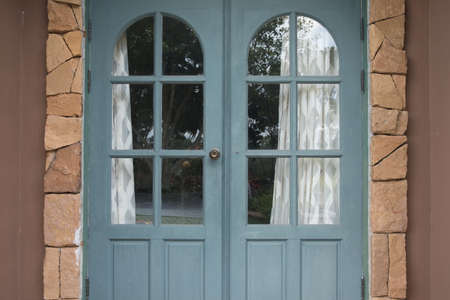 Closed green or blue wooden door of house. Vintage front door abstract background.の写真素材