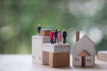 Miniature people contact and agreement banking to contact for approve home loans. Concept of the financial loans between the lender and the borrower. Secured and mortgage loan.の写真素材