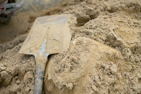 Shovel on a pile of sand for construction work. Concept work at the construction site