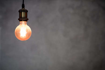 Select focus light bulbs hanging of with gray wall. Loft style interiorの写真素材