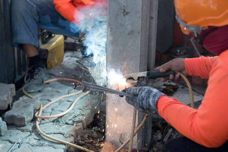 Construction worker with small piling, Concrete foundation pile head (micropile), hammered Into the...