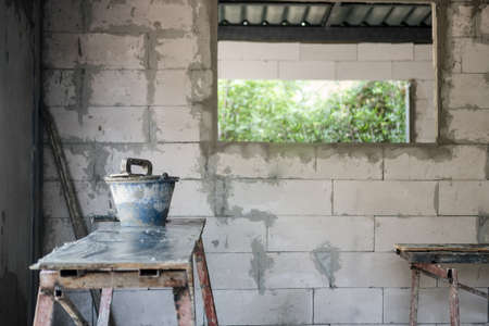 Tools cement boxes baskets in renovating room. Repairing and working in home. Renovation concept