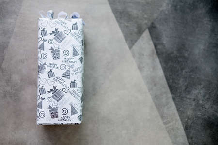 Gift box wrapped in with paper. Birthday surprise concept.