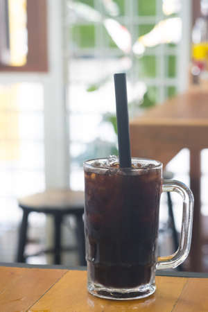 Thai iced black coffee signature local beverage on wooden background called oliangの写真素材