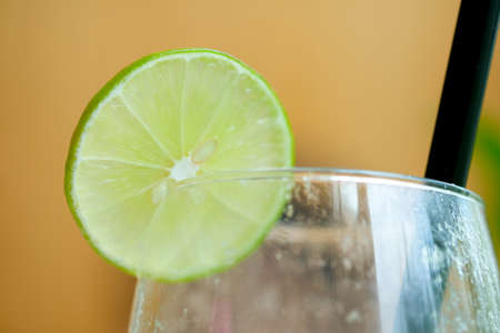 A slice of lemon decoration on glass. Selective focus