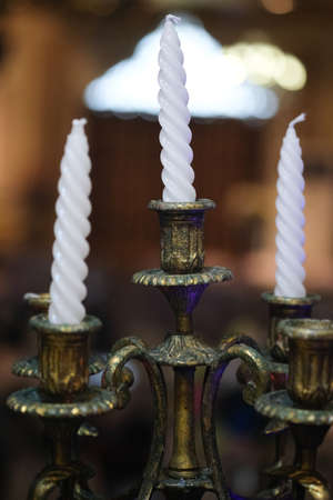 Beautiful white candles in classic candlestick. Wedding decorations.の写真素材