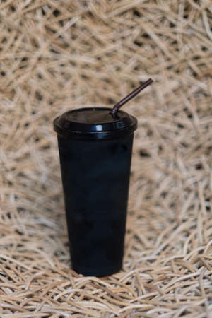 Black plastic cup with tube, take away plastic packageの写真素材