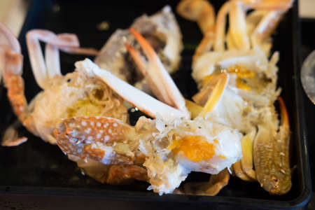 Fresh sea crab and egg crab premium grade on black trayの写真素材