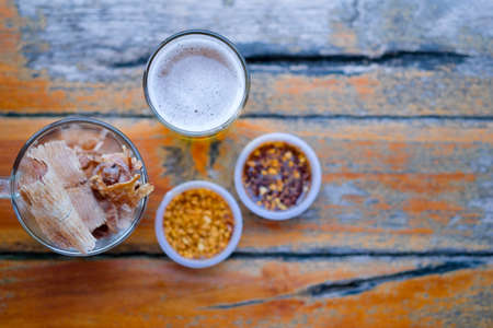 Thai food dried squid grilled grinding served with spicy sauce sprinkled with peanuts. Eating appetizer with beer. Thai styleの写真素材