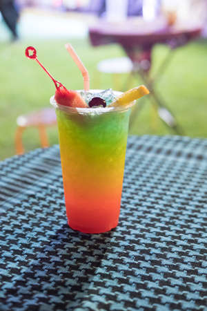 Drink of fresh mix fruit and soda decorate with orange sliced at outdoor cafe