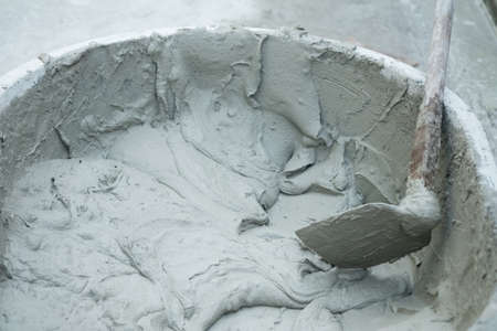 Mixed mortar cement in container ready to be used