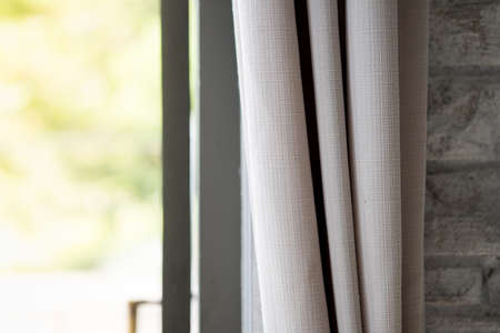 Beige curtain by the window in bed room