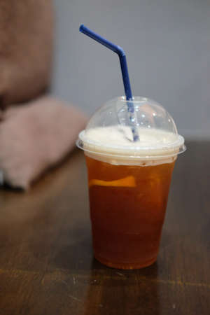Orange and coffee with ice on wooden tableの写真素材