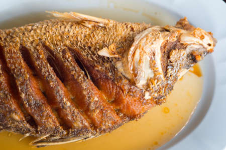 Fried snapper topped with fish sauce, Thai style food