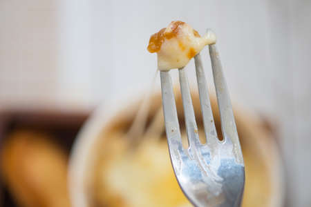 Selective focus of cheese on forkの写真素材
