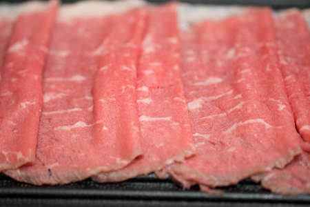 Fresh sliced beef for grill serving on black tray