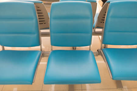 Blue seat waiting for departure passengers in airportの写真素材
