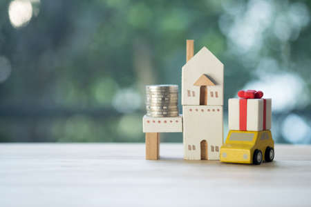 Saving money for having a car with a home in the future. concept of essentials for life ideaの写真素材