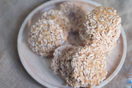 Rice cracker or rice biscuit topping with cane sugar on wood plate - Thai dessert