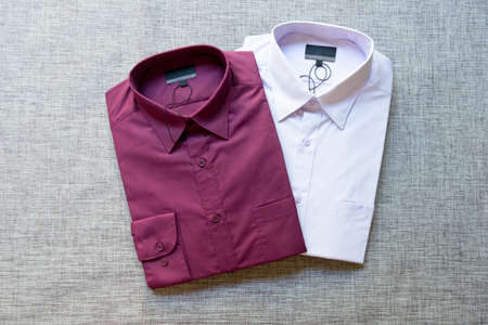 Close up of a collection of violet folded men's shirtsの写真素材