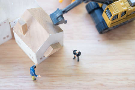 Miniature people banker seize asset because gambling. Concept settlement of litigation.