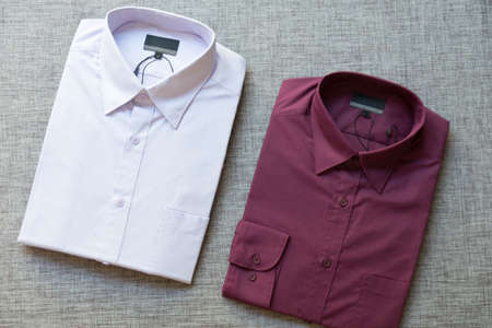 Close up of a collection of violet folded men's shirtsの写真素材