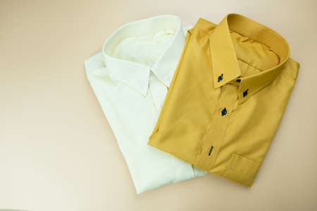 Stylish new bright men's yellow shirts fashionable on a yellow background.の写真素材