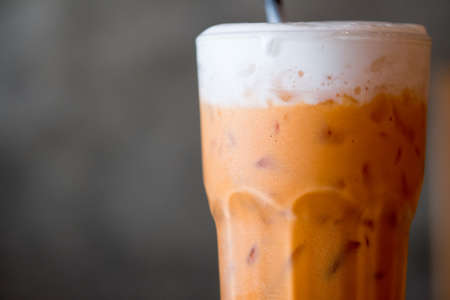 A glass of Thai iced milk tea, blank for copy space.の写真素材