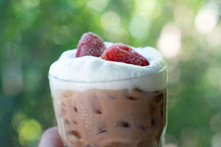 Chocolate drink with freeze strawberry put on milk foam arrange with nature backgroundの写真素材