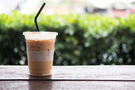 Iced espresso on the wooden table with nature light background, Iced coffee and space backgroundの写真素材