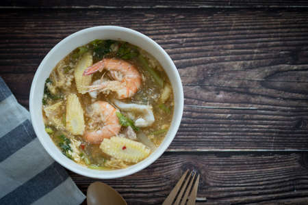Seafood shrimp, squid and vegetable homemade suki in white bowlの写真素材