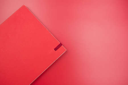 Close up red paper notebook on red background