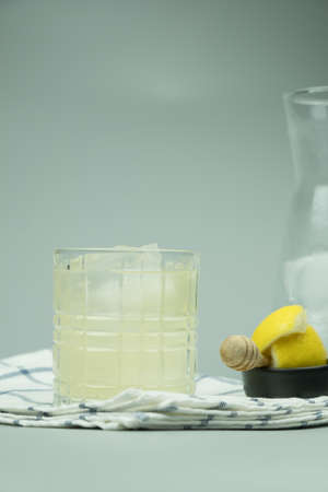 Cocktail glass of lemonade and ice cubes. Refreshing cold drinkの写真素材