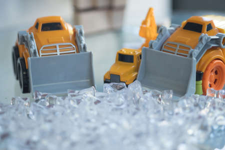 Toy yellow plastic loader excavator for moving