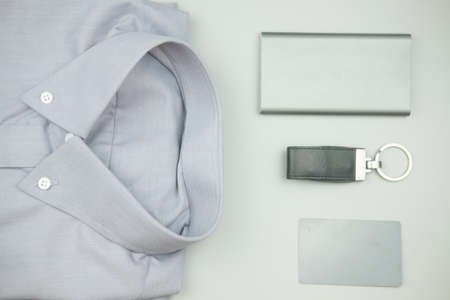 Items for men set : Classic gray clothing , leather flash drive, credit card, smart phone charger on...