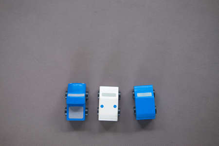 Three of toy wooden cars on gray background. Educational toys for children