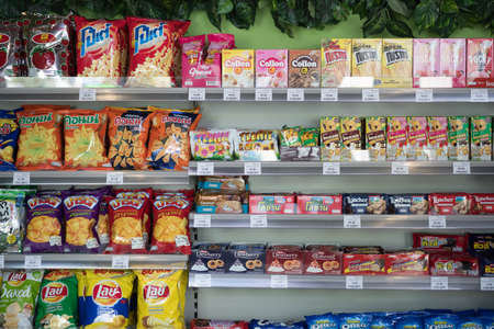 BANGKOK, THAILAND : APRIL 12, 2019 - The Inthanin coffee shop where is coffee houses franchise in Thailand add on many snack were fully fill up on the shelves section in new coffee shop, Inthanin. Ready for consumer to purchase.のeditorial素材