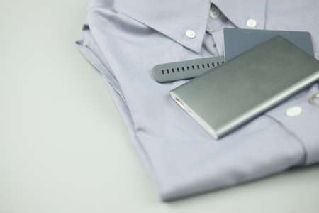 Gray colour clothing and electronic item gray colour (silver power bank, smart watch and credit card) on gray backgroundの写真素材