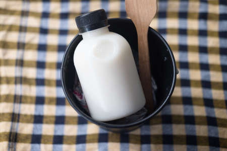 Plastic bottle of fresh milk served in basketの写真素材