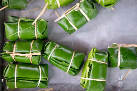 Banana with sticky rice covered in banana leaf before steamer. Traditional Thai food style