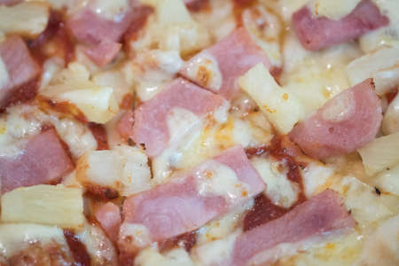 Delicious thin flame grilled ham and pineapple pizza with cheeseの写真素材