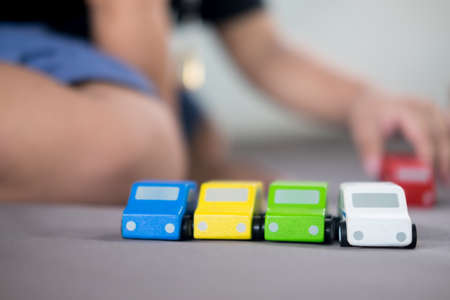 Colorful of wooden toy car with blur of cute kid background